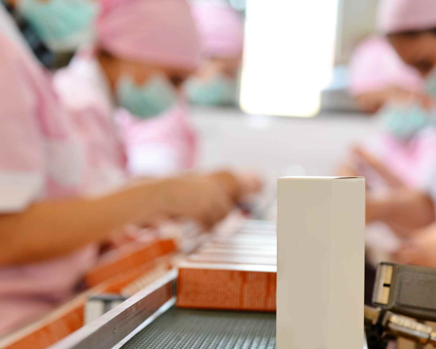Production line with workers wearing pink
