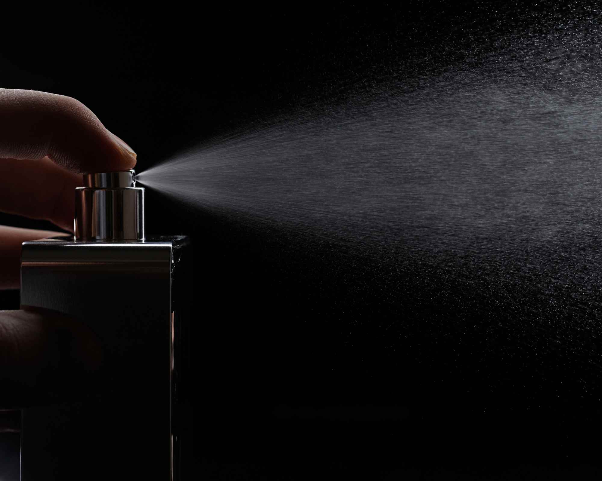 Hand spritzing a perfume