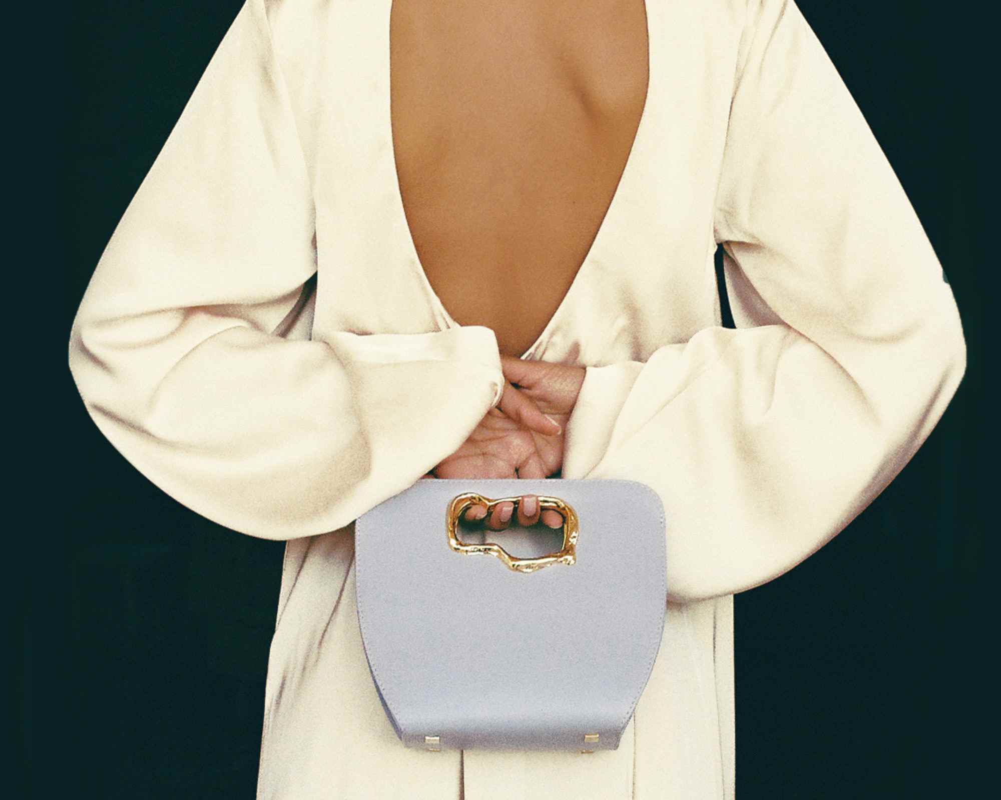 Person in satin dress holding Mashu vegan bag