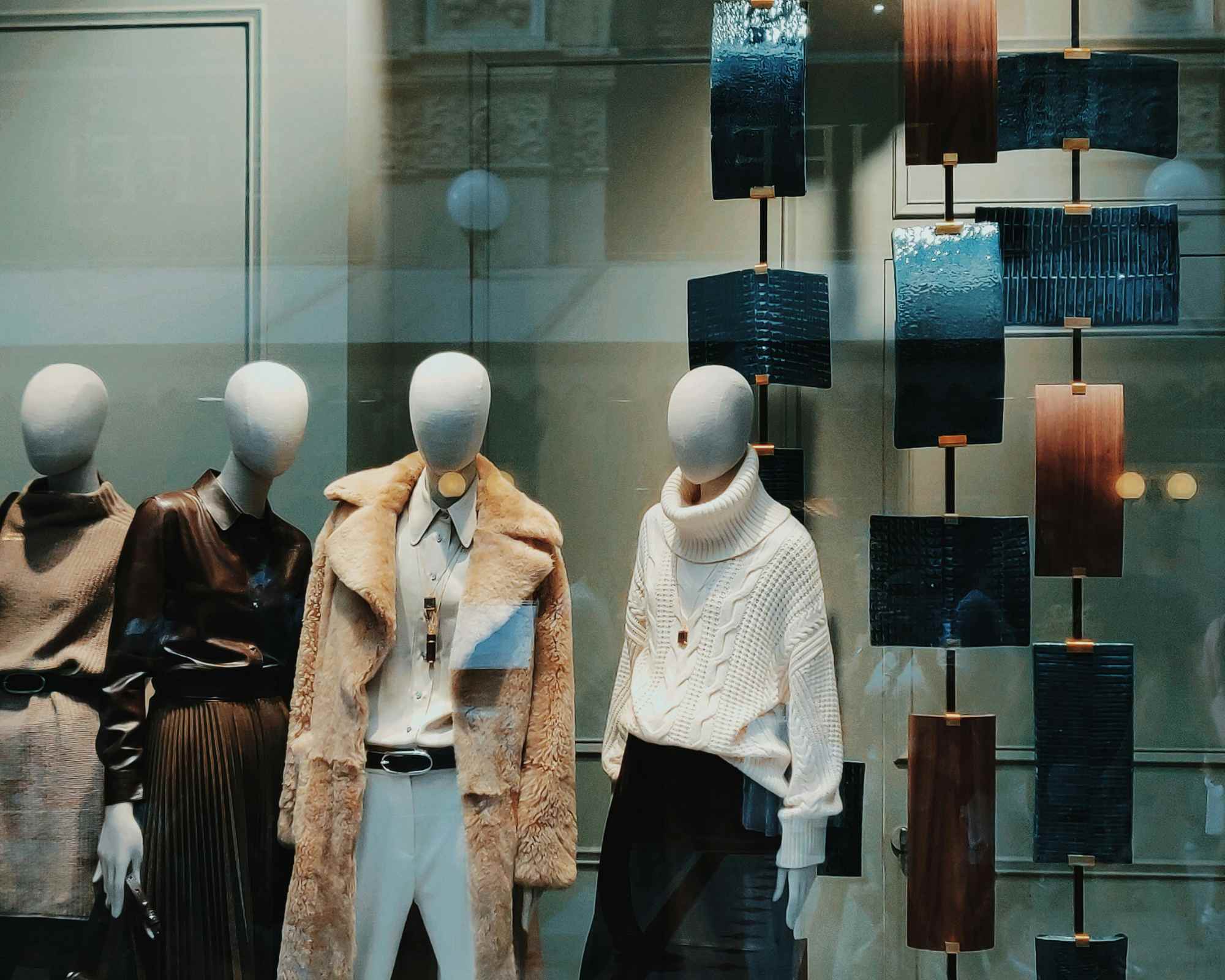 Shop window with reflections and fashion mannequins
