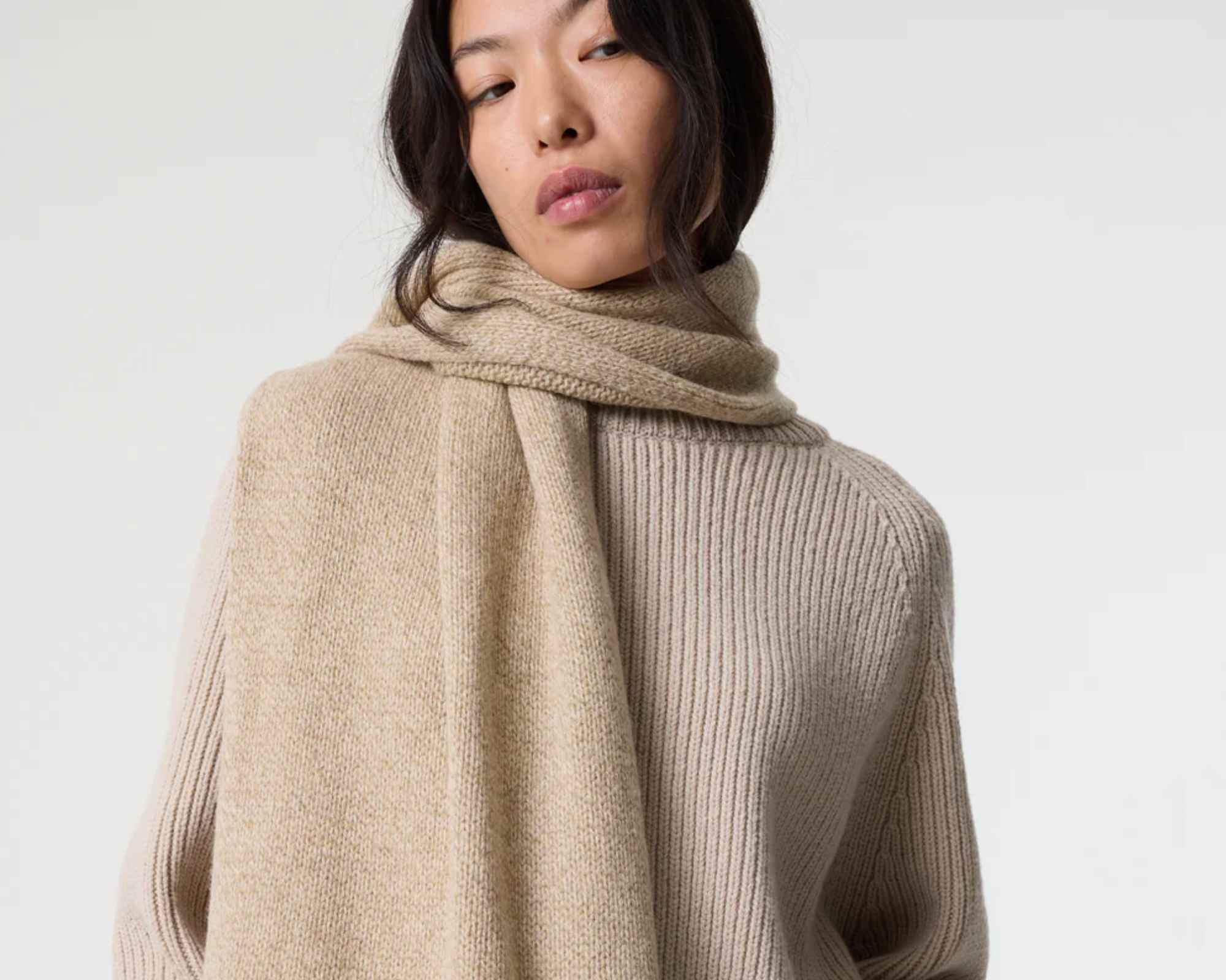 person wearing akyn knitted scarf and sweater