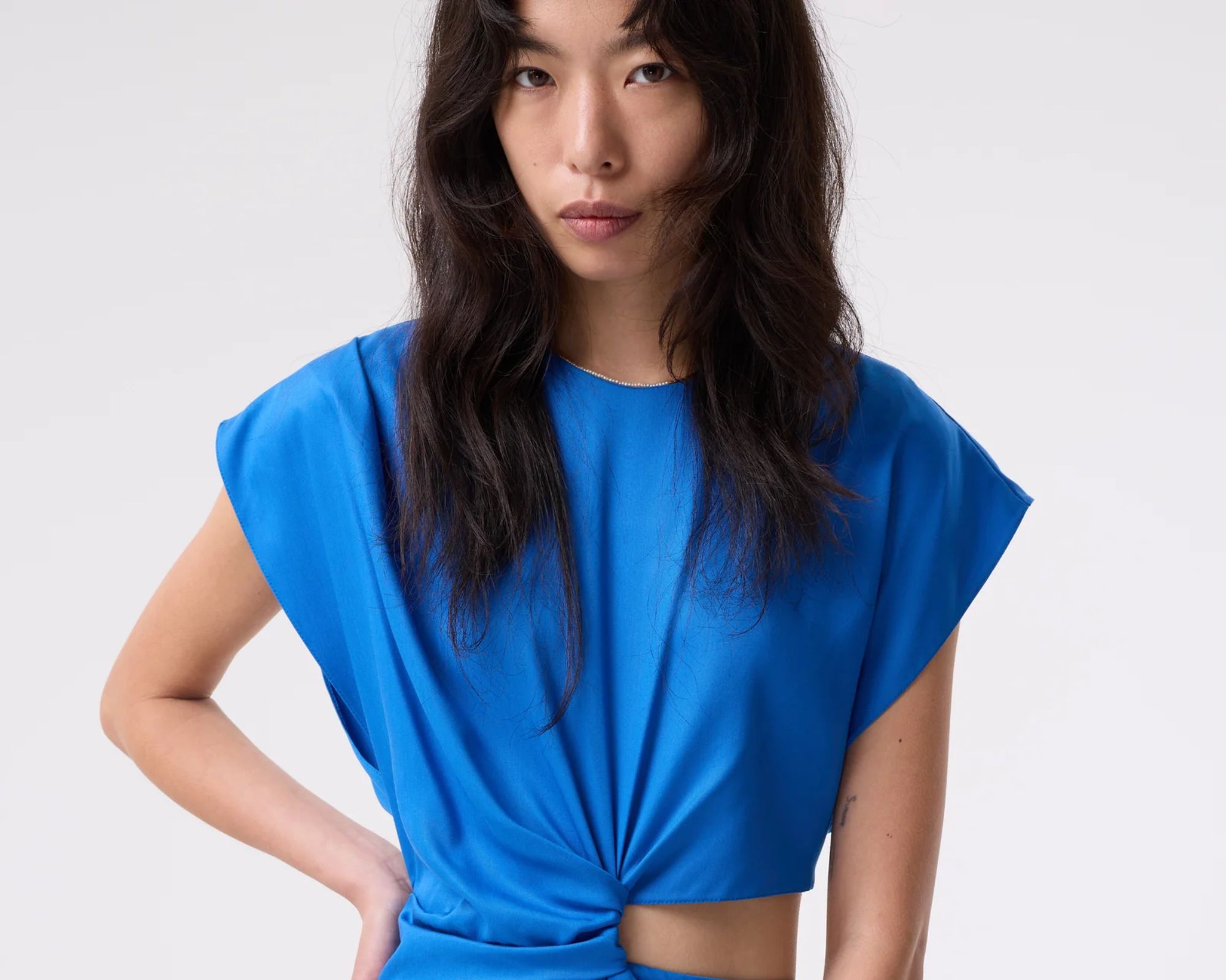 person wearing gathered blue investment dress from akyn