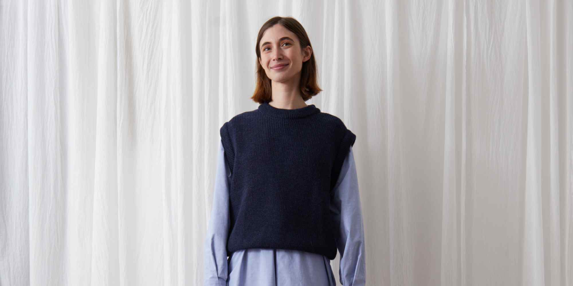 person wearing sweater vest from studio de lostanges