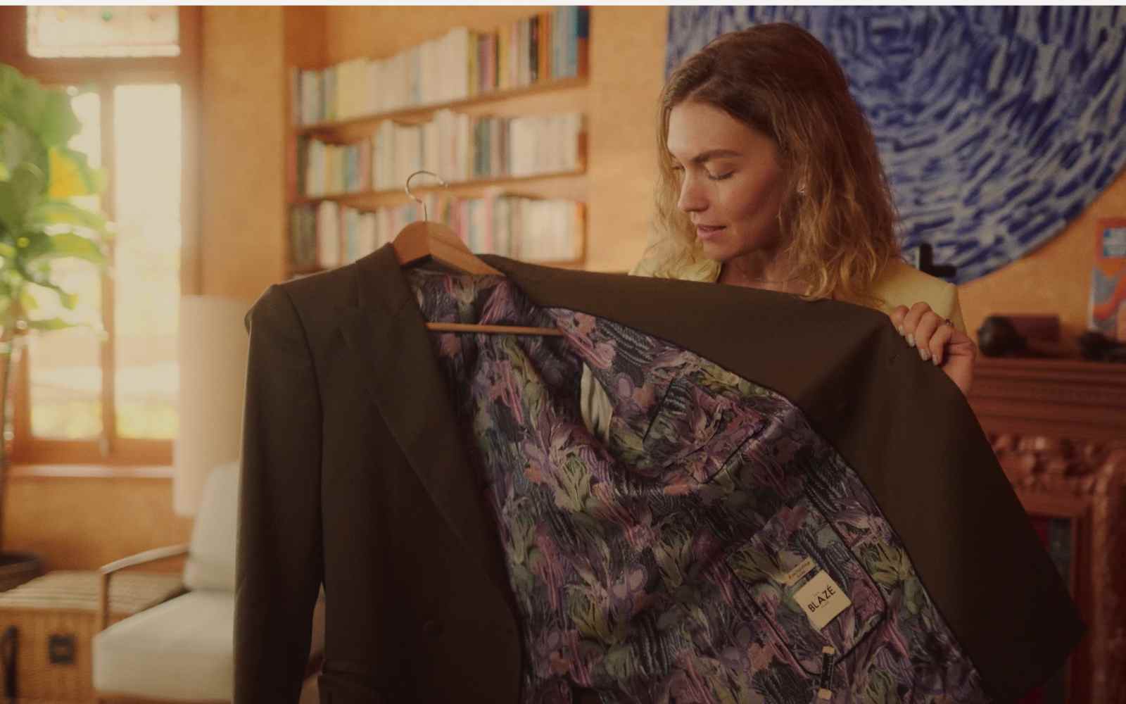 arizona muse holding a brown blazer in a video with imagine5