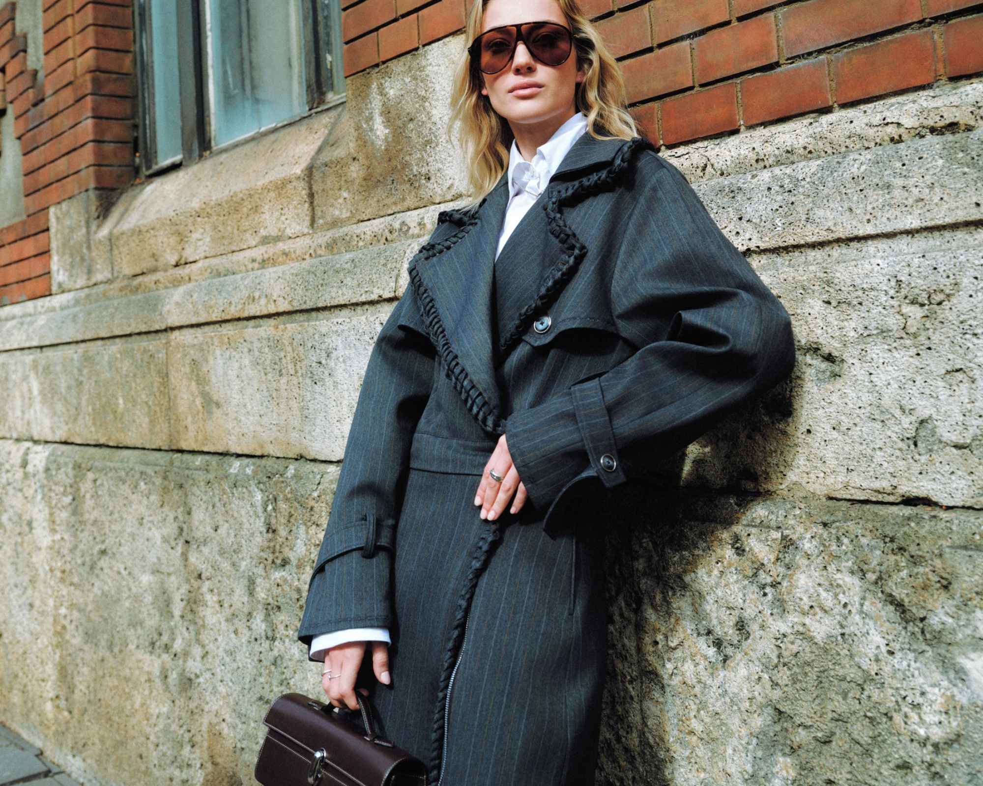 person wearing bastet noir trench coat