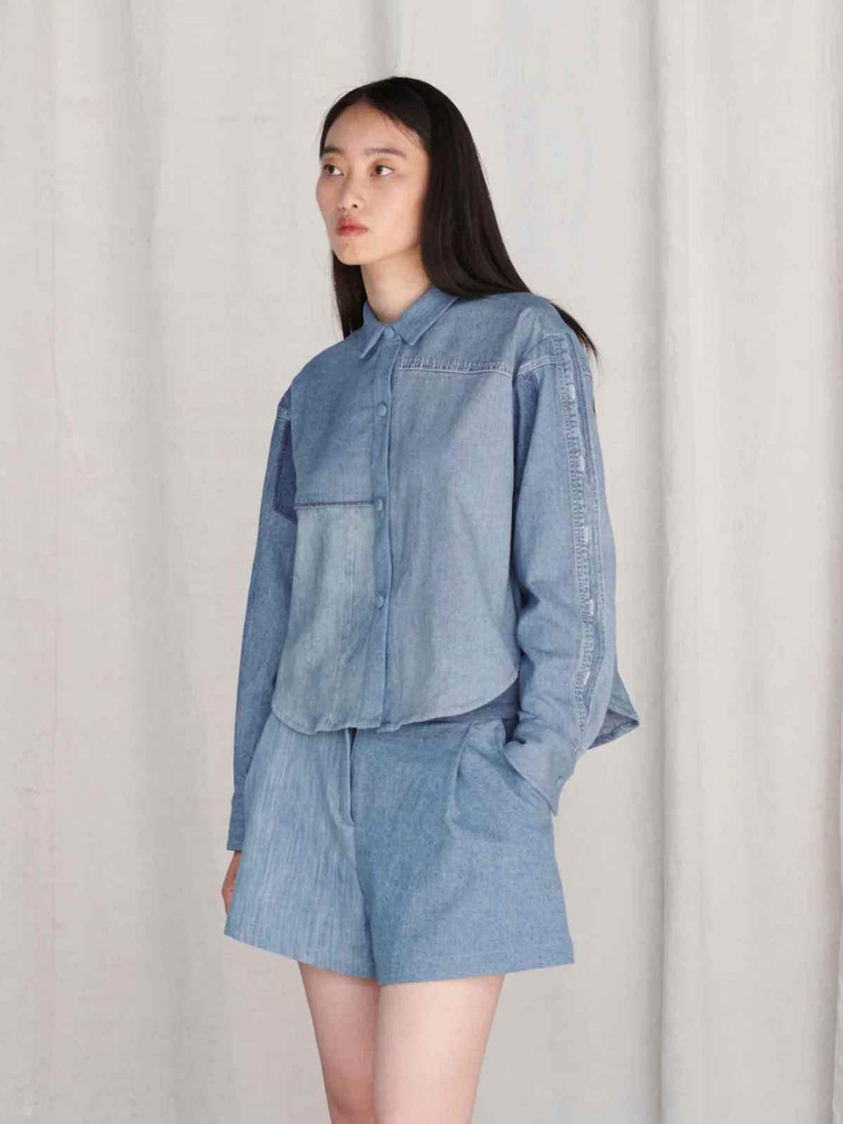 person wearing blue denim shirt from e.l.v denim