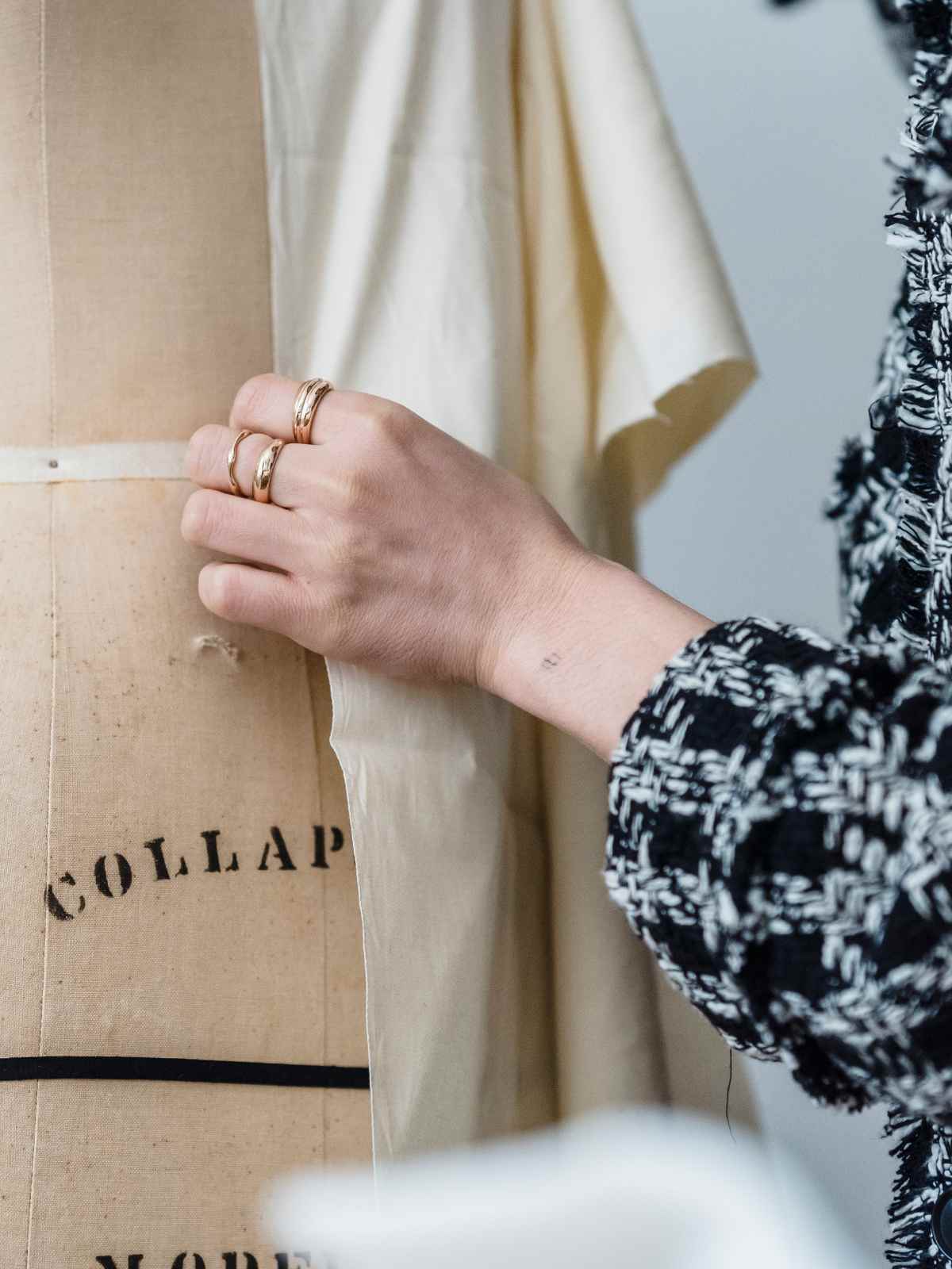 person touching dressmaker's mannequin