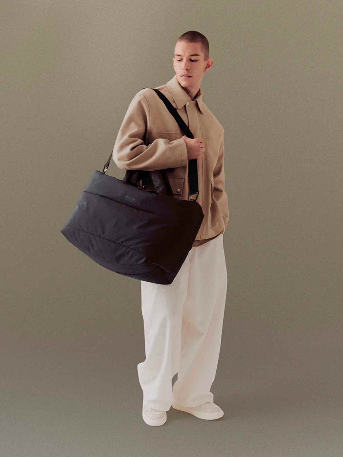 person carrying ucon acrobatics more sustainable travel bag