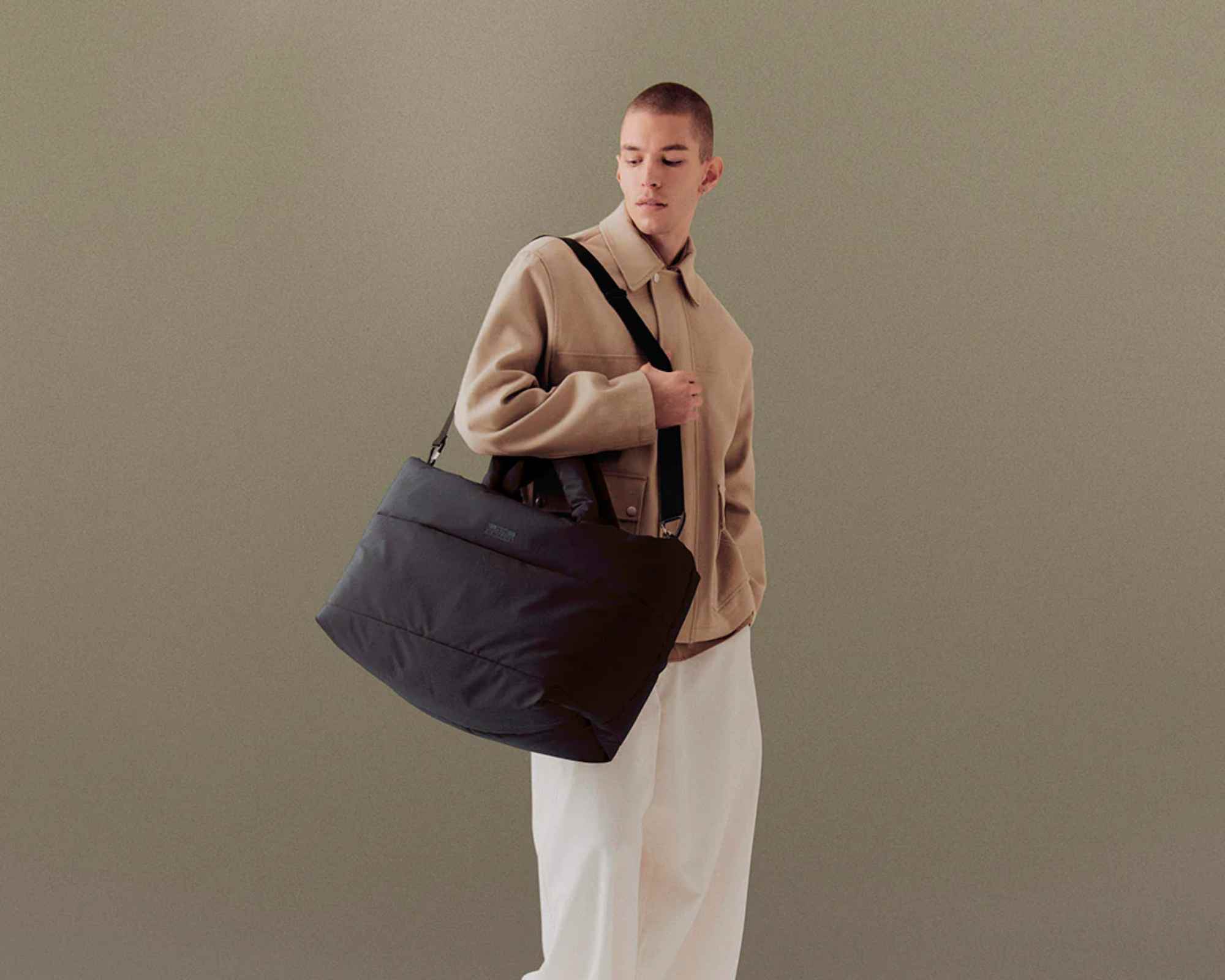 person carrying ucon acrobatics more sustainable travel bag