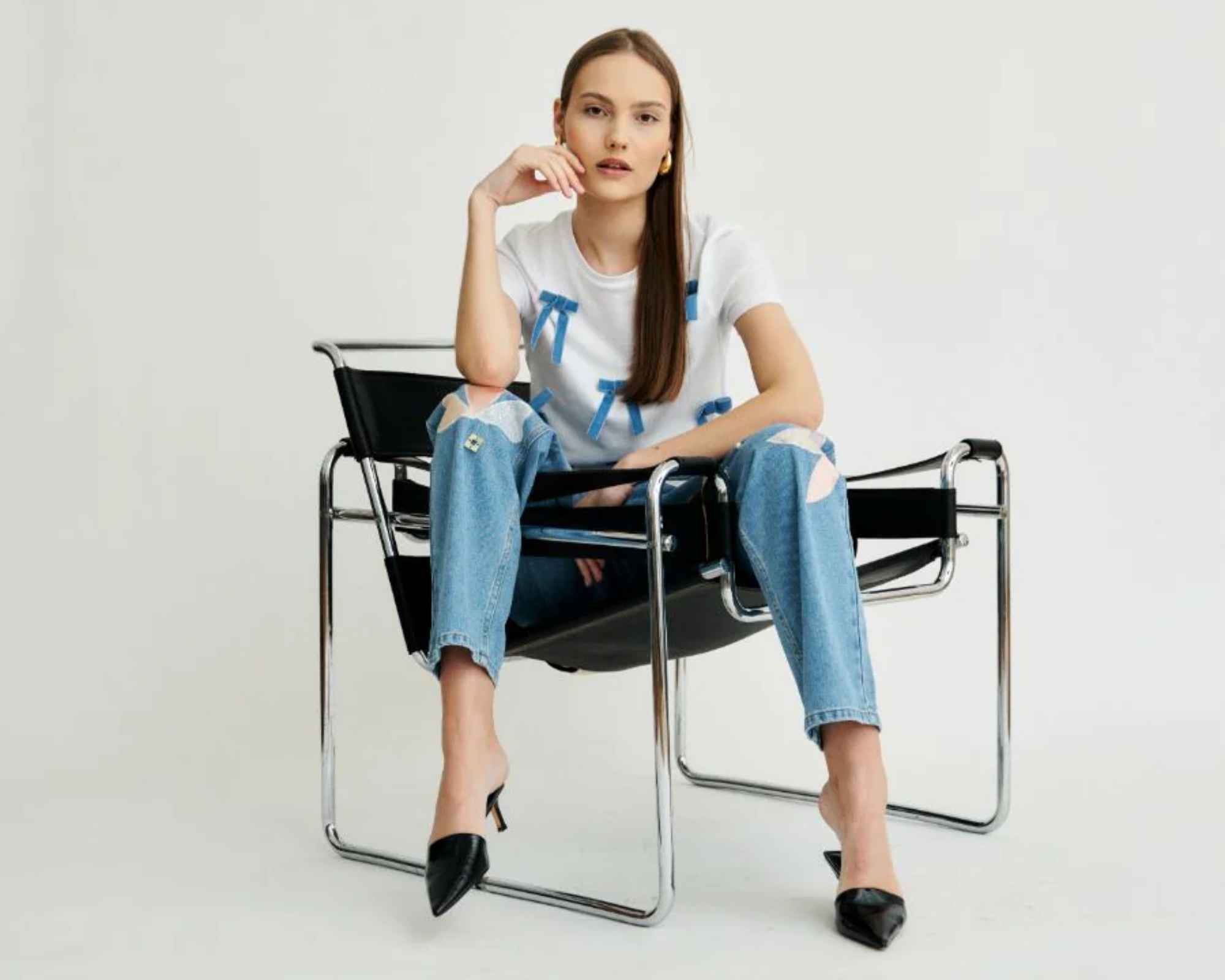 person wearing bow-applique fanfare t-shirt