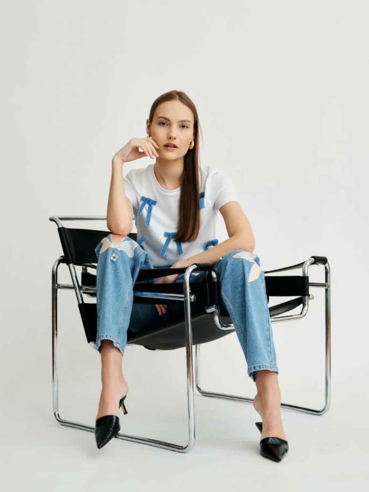 person wearing bow-applique fanfare t-shirt