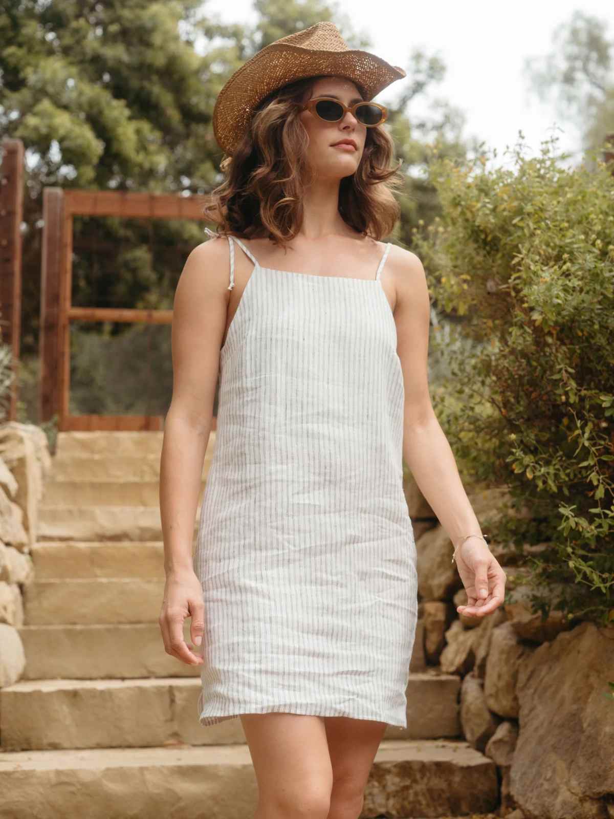 person wearing more sustainable linen mini dress from whimsy and row
