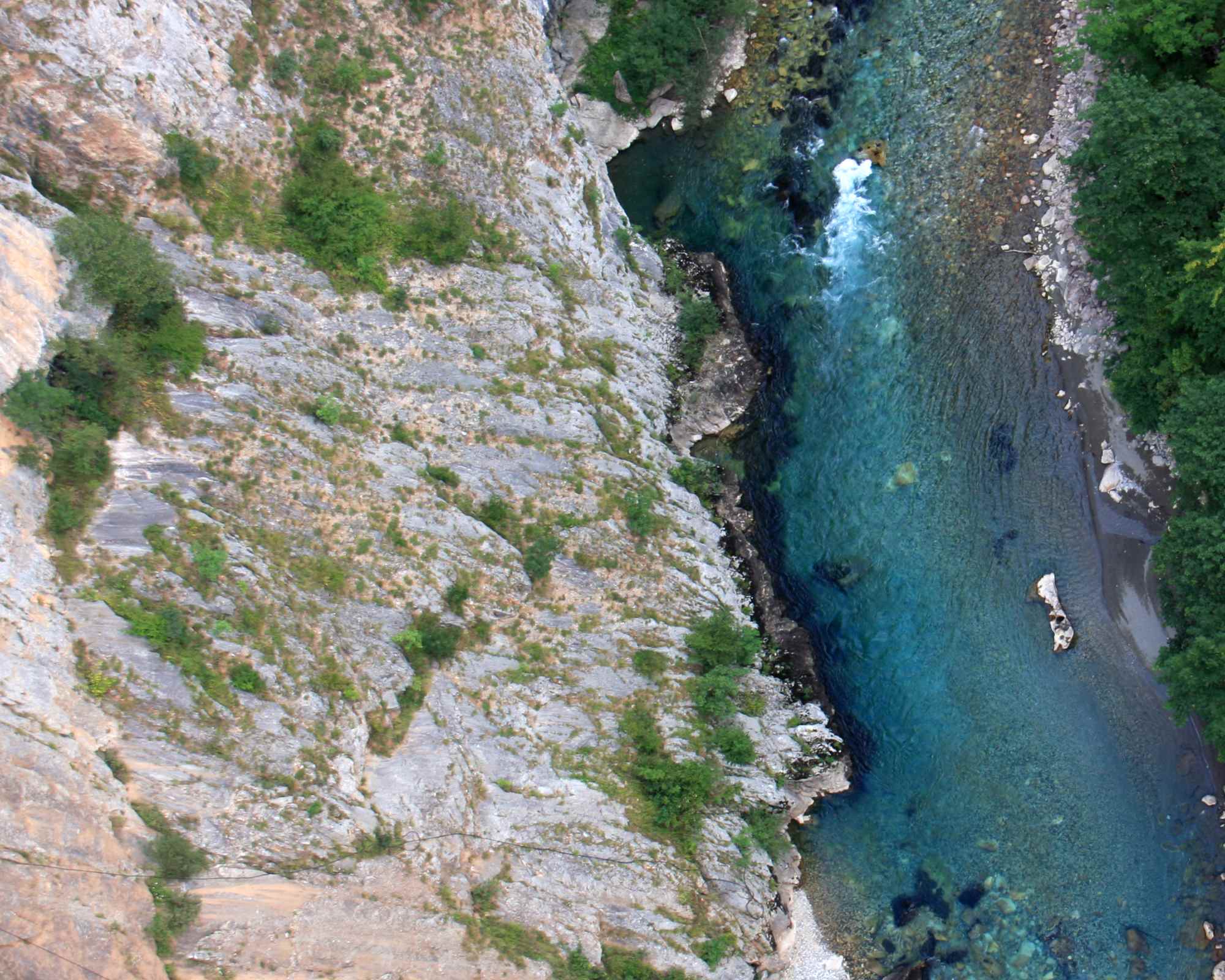 river and rock face from above