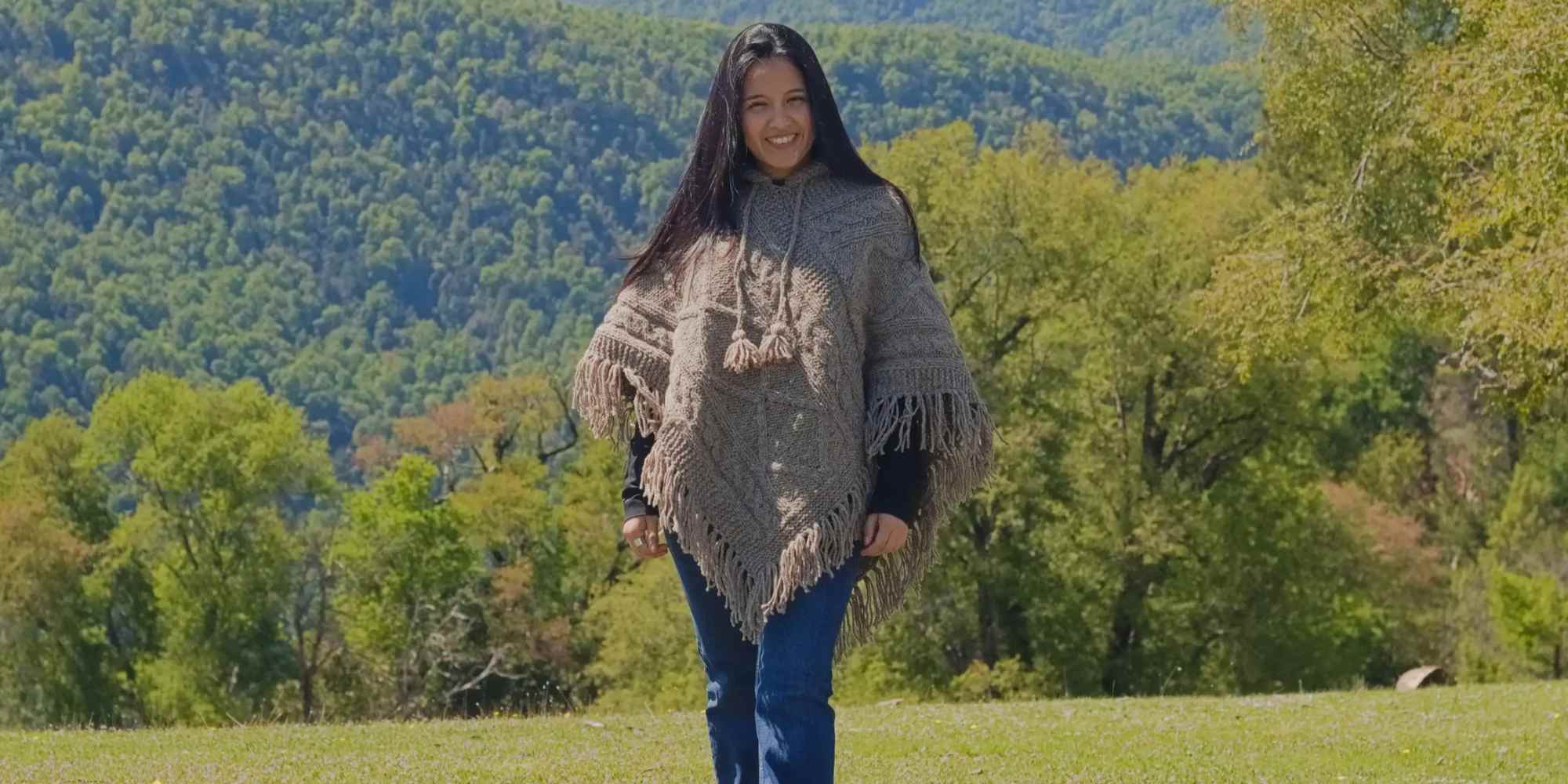 person wearing handmade poncho from rise of andes